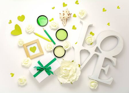 Valentines day, wedding, engagement green flat lay, top view. Present gift box, ribbon, hearts, rose flowers, sign Love, white paper. Banner template, copy space. Holiday concept mock up greeting cardの写真素材