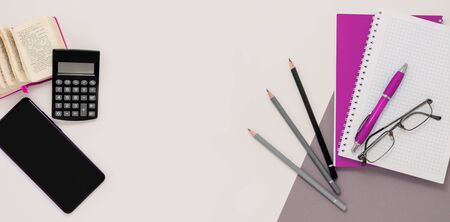 Stay at home white background flatlay. Home office smartphone pink notebook dictionary book top view template long banner. Copy space backdrop mock up design. Distance education creative work concept.の写真素材