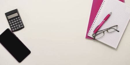 Stay at home white background flatlay. Home office smartphone pink notebook glasses pink pen top...