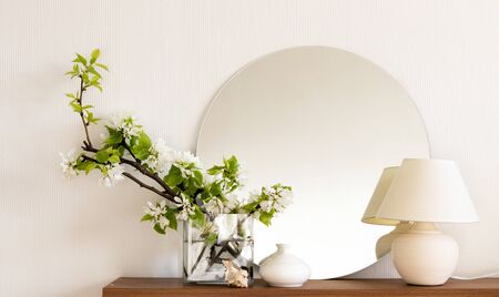 White living room minimalist interior shelf mockup. Decoration living room home interior. Cozy interior shelf round mirror lamp flowers vaze. Room modern white empty wall. Copy space backdrop designの写真素材