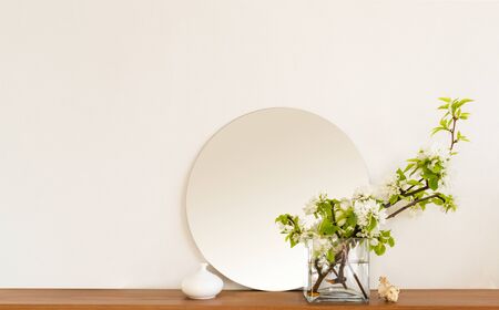 White living room minimalist interior shelf mockup. Decoration living room home interior. Cozy interior shelf round mirror apple flowers vaze. Room modern white empty wall. Copy space backdrop designの写真素材