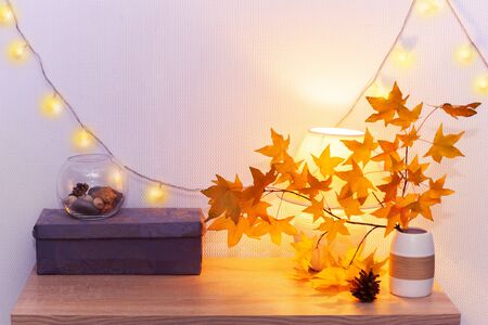 White living room minimalist interior shelf mockup. Autumn decoration room home interior. Cozy light garland yellow maple leaves lamp. Modern empty wall. Copy space selective focus long banner designの写真素材