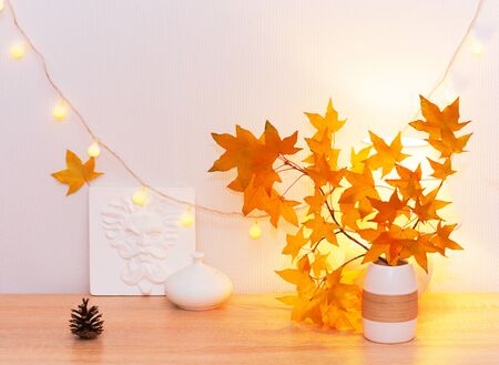 White living room minimalist interior shelf mockup. Autumn decoration room home interior. Cozy light garland yellow maple leaves lamp. Modern empty wall. Copy space selective focus long banner designの写真素材