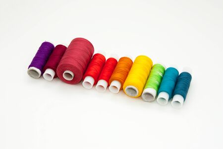 Flat lay with colorful cotton thread spools, embroidery yarn, rainbow bobbins, mock up, top view....