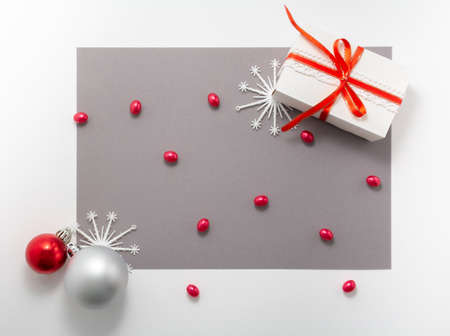 2020 Merry christmas decorations flatlay. Gift, red ribbon, snow flakes, balls top view. New year...