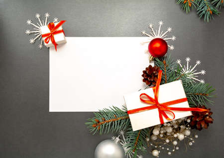 2020 Happy New Year, Merry Christmas decorations flatlay. Gift boxes, red ribbon, balls, spruce branch, snowflakes top view. Boxing Day banner template, black paper, copy space. Xmas concept mock up.の写真素材