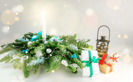 Christmas table decoration banner. Green fir branches candle gift boxes blue balls lights isolated white background. Minimalist home new year decor old style. Xmas concept copy space mock up bannerの写真素材