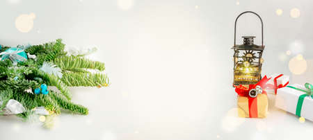 Christmas table decoration banner. Green fir branches candle gift boxes blue balls lights isolated white background. Minimalist home new year decor old style. Xmas concept copy space mock up bannerの写真素材