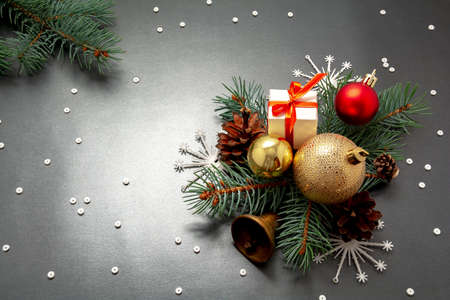 2021 New Year Christmas decorations flatlay. Gift box ribbon golden balls spruce branch pinecone bell snowflakes top view. Boxing Day banner template black white paper copy space. Xmas concept mock upの写真素材