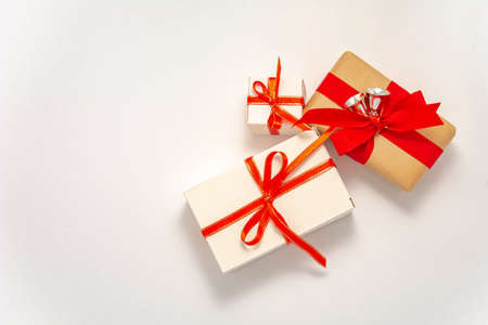 2021 Happy New Year, Merry Christmas decorations flatlay long banner. Gift boxes red ribbon silver bells top view. Boxing Day template craft white paper frame copy space. Xmas concept greeting mockupの写真素材