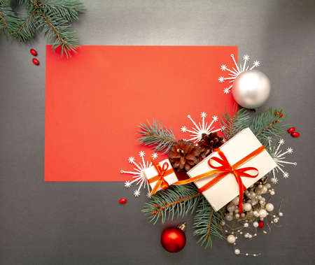2021 Happy New Year, Merry Christmas decorations flatlay. Gift boxes red ribbon, balls spruce branch snowflakes top view. Boxing Day banner template black red paper copy space. Xmas concept mock up.の写真素材