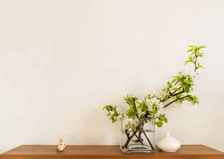 White living room minimalist interior shelf mockup. Decoration living room home interior. Cozy interior shelf apple flowers vaze. Room modern white empty wall. Copy space backdrop designの写真素材