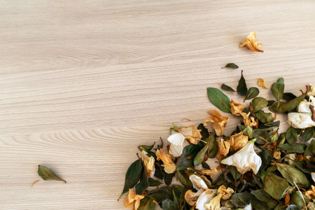 Dry flowers leaves on wooden table top view. Colorful herbs tea flat lay.の写真素材