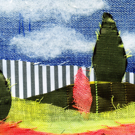 Fabric art applique Illustration. Patchwork forest landscape with trees, hills and sky. Original graphic illustration with jeans striped fabric flaps. Decorative landscape hand made recycled trash artの写真素材
