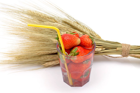 Ripe strawberries in a glass isolated on whiteの写真素材