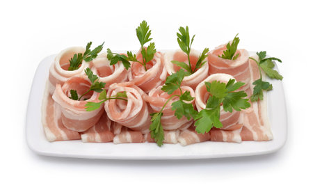 Rolled bacon with parsley isolated on white. Top viewの写真素材