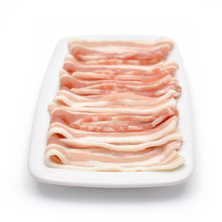 Bacon bits laid out on a plate. Isolated backgroundの写真素材