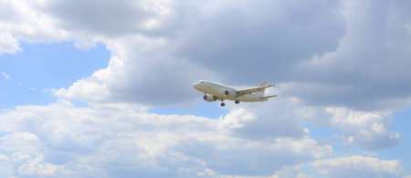 Airliner with landing gear takes off in the blue sky.の写真素材