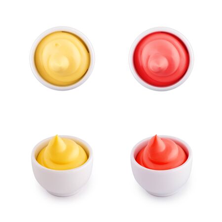 Set of ceramic gravy boats with cheese sauce and ketchup on a white backgroundの写真素材