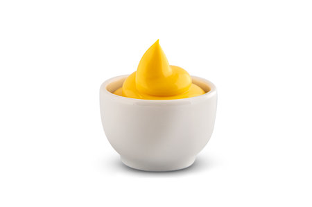 Ceramic gravy boat with cheese sauce on a white backgroundの写真素材