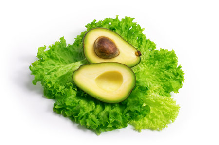 Avocado on lettuce salad leaves top view isolated on white backgroundの写真素材