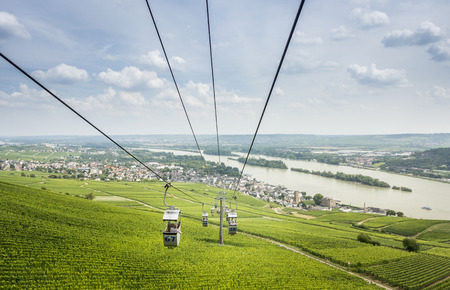 View of the river Rhine and Rudesheim with cable cars in the foreground passing over vineyardsのeditorial素材
