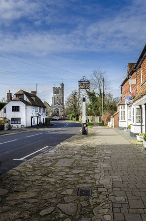 BIDDENDEN, Kent, UK, JANUARY 2015 - High street with cobbled pavement, historic buildings and church in the backgroundのeditorial素材
