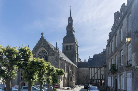 DINAN, BRITTANY, FRANCE, 15 JUNE 2015 -  medieval cobbled street and the Basilique Saint-Sauveur, church in the city of Dinan, Brittany, Franceのeditorial素材