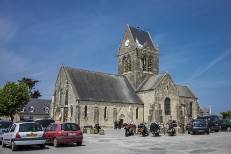 SAINTE-MERE-EGLISE, FRANCE -  27 JUNE 2013 - Paratrooper hanging from church, St. Mere Eglise on 27 June 2013 in Normandy, France. A memorial to the city's liberation by the Allies during the invasionのeditorial素材