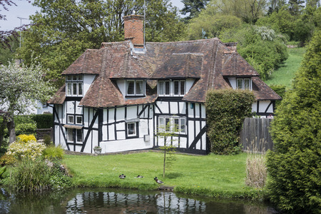 LOOSE, KENT, UK, 11 MAY 2015 - Pretty half timbered cottage in the village of Loose, Kent, UK with the Loose river in the foregroundのeditorial素材