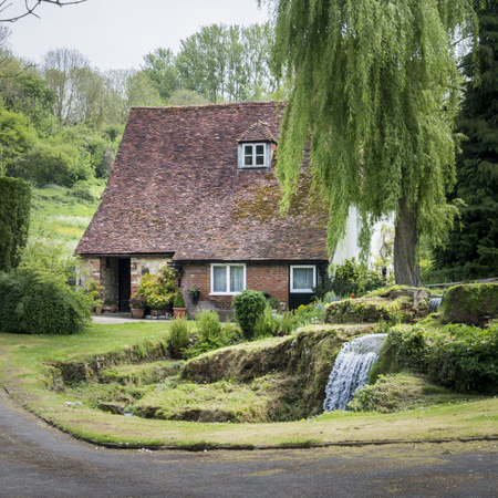 Old cottage with waterfall in the garden, in the pretty village of Loose, Kent, UKの写真素材