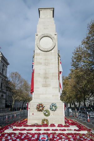 The historic Cenotaph War Memorial located on Whitehall in London, adorned with poppy wreathsのeditorial素材