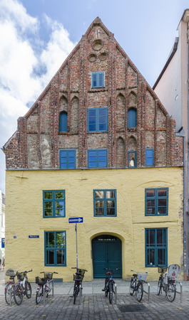 Old gothic building with several bicycles parked outside, Stralsund, Germanyのeditorial素材