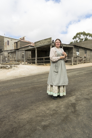 A lady in traditional costume in Sovereign Hill, an open air museum in Golden Point, a suburb of Ballarat, Victoria, Australia. Sovereign Hill depicts Ballarat's first ten years after the discovery of gold there in 1851.のeditorial素材