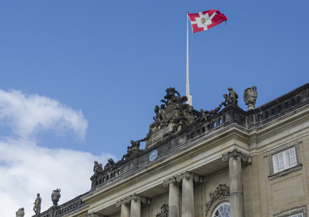 The Danish Royal flag flying above Amalienborg Palace, Copenhagen, Denmarkのeditorial素材