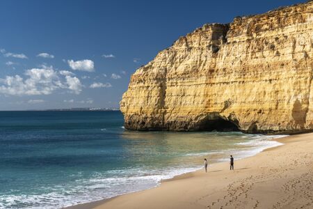 Two people on the beach in Carvoeiro in the Algarve in Portugal
