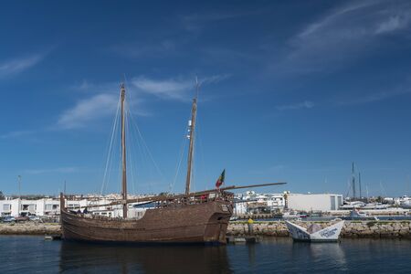 Large brown wooden sailing boat in the water
