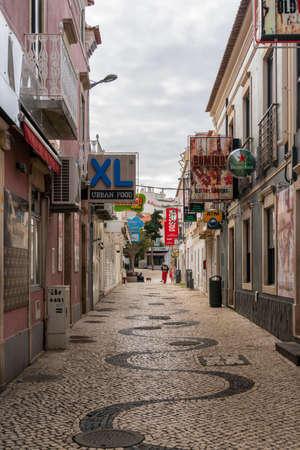 Patterened cobblestones on a narrow street in Albufeira, Algarve, Portugalのeditorial素材
