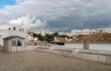 Stormy skies over the rooftops of Albufeira, Algarve, Portugalのeditorial素材