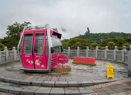 View of a Ngong Ping 360 cable car with the Tian Tan Big Buddha in the distance, Lantau Island, Hong Kongのeditorial素材