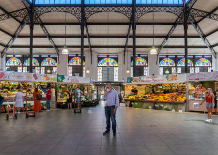 A man holding a telephone conversation in the indoor market in the city of Salamanca, Spainのeditorial素材