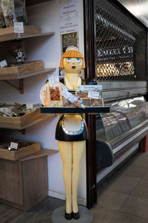 A pretty waitress statue displaying a tray of buscuits in the market in the city of Salamanca, Spainのeditorial素材