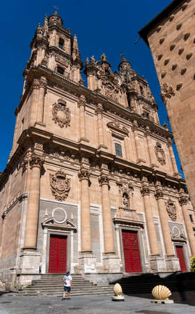 A man wearng a face mask to protect from Corona Virus, in front of a Baroque Catholic church  in the city of Salamanca, Spainのeditorial素材