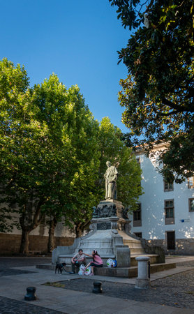 People sitting at the foot of a monument to Eugenio Montero Rios in the city of Santiago de Compostela, Spainのeditorial素材