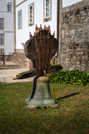 An ancient bell on the grass in the grounds of the Convent of Saint Francis, Santiago de Compostela, Spainのeditorial素材