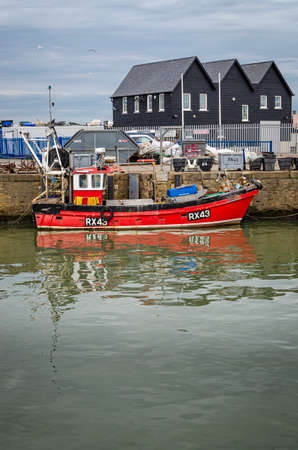 Whitsable, Kent, UK, February 2021 - Red fishing boat in the harbour at Whitstable, Kent, UKのeditorial素材
