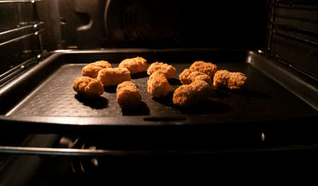 Frozen scampi being baked in an ovenの写真素材