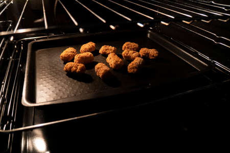 Frozen scampi being baked in an ovenの写真素材