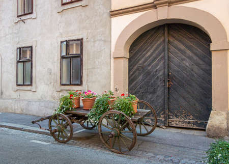 Wooden cart with flower pots on in front of an historic building in the city of Zagreb, Croatiaの写真素材