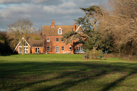 A house and garden in the countryside in winter sunlight, UKのeditorial素材